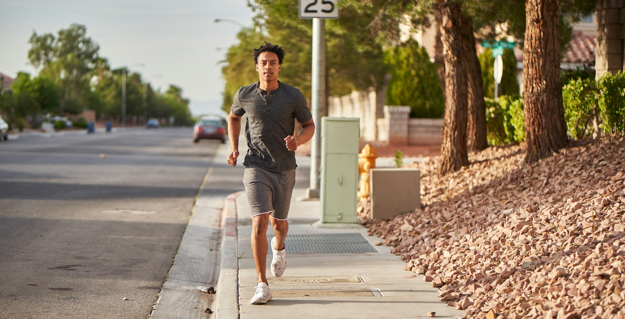 african american man running and exercising on las vegas sidewalk